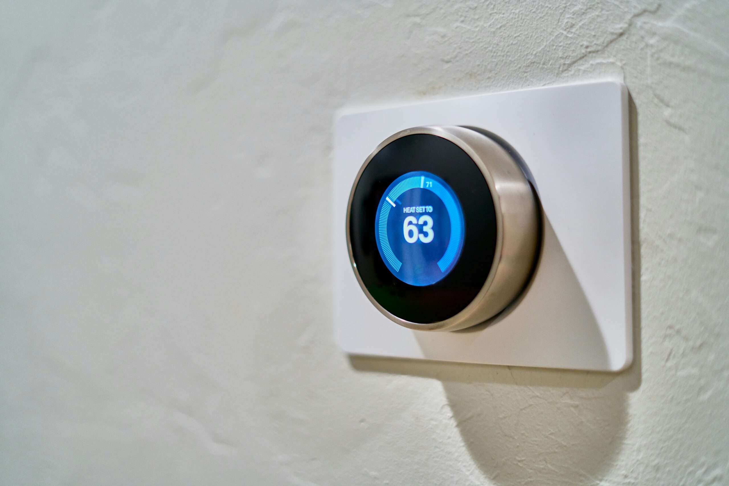 Smart thermostat displaying temperature control options on a digital screen